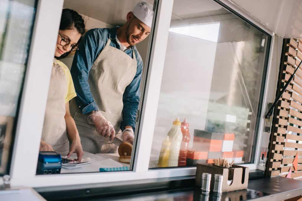 young couple working in a food truck