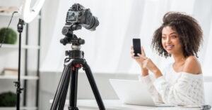 attractive woman with videocamera - freelance videographer hourly rate